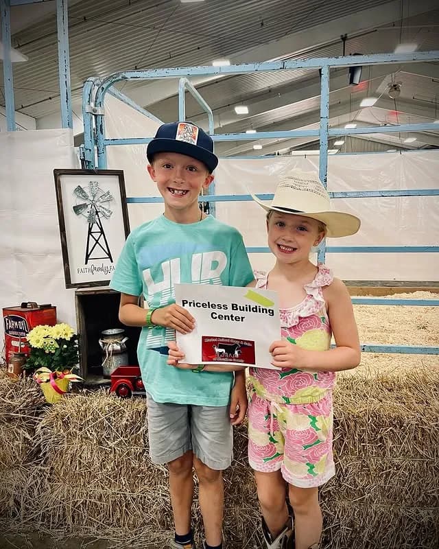 Kids holding Price-Less sign at the county fair