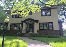 Yellow stucco home with arched front entry