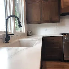 Walnut shaker with white marble counter.