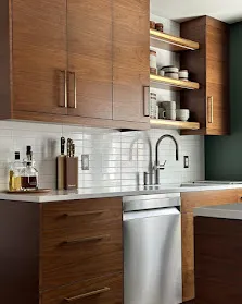 A representative bone-white inset kitchen with island, integrated paneling, warm lighting. The kind of work Builders Corner designs.