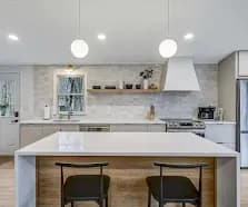 Two globe pendants, modern bar stools, quartz top.