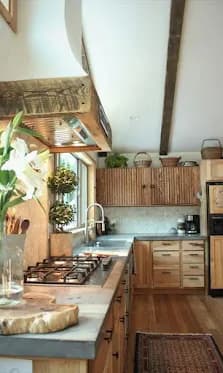 Stained wood cabinetry with a reclaimed-wood vent shroud.