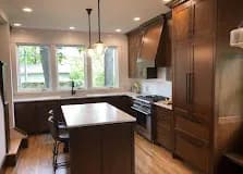 Two-tone: Different finishes on the perimeter and the island. Adds depth without changing door style.