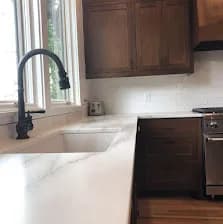 Walnut shaker cabinets, white marble counter, matte black gooseneck.