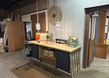 Rustic wood counter, vintage clock, soft lamp lighting. Where you actually talk to a person.