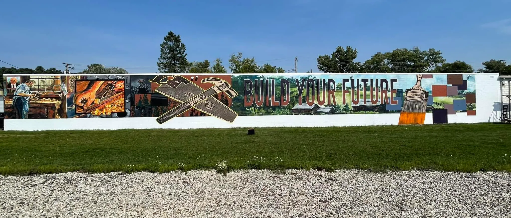 The 'Build Your Future' community mural on the side of the Price-Less Building Center, painted by fifty Wausau volunteers in June 2023.